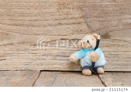 Teddy Bear toy with black color pencil on wood background 21115174