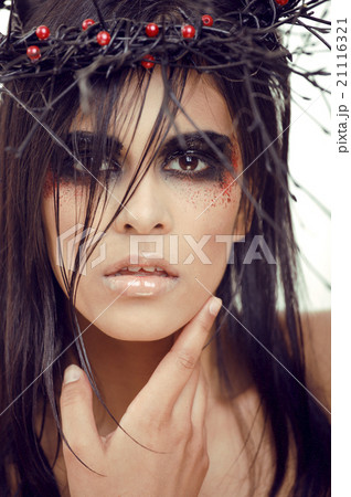 pretty brunette woman with make up like demon at pretty brunette woman with make up like demon at 21116321