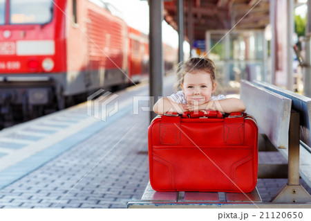 little girl with big red suitcase on a railway little girl with big red suitcase on a railway 21120650