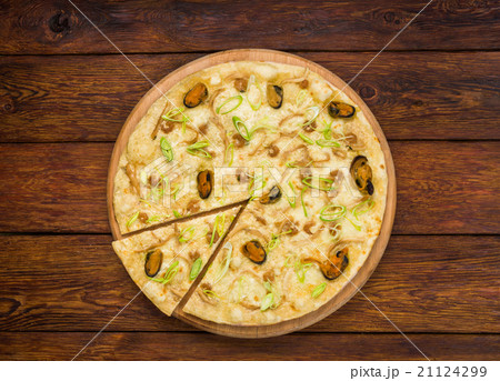 Italian seafood pizza top view at wood background 21124299
