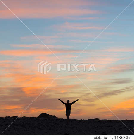 Woman enjoying freedom at sunset. Woman enjoying freedom at sunset. 21136387