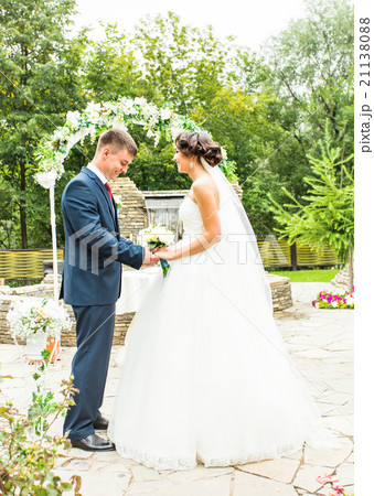 Couple Getting Married at an Outdoor Wedding 21138088