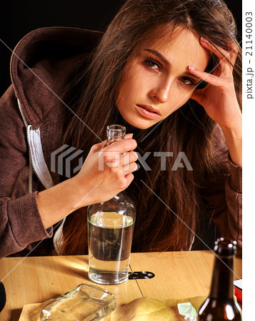Drunk girl holding bottle of vodka. Drunk girl holding bottle of vodka. 21140003