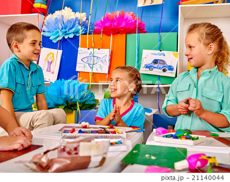 Group kids mold from plasticine in kindergarten . Group kids mold from plasticine in kindergarten . 21140044