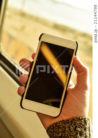 young man using a smartphone in a train or a bus 21144799