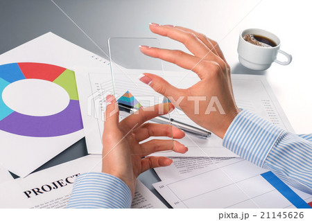 Lady's hands touching transparent smartphone. Lady's hands touching transparent smartphone. 21145626