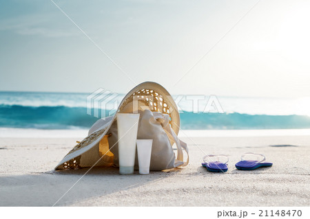 Sun lotion, hat  with bag at the tropical beach 21148470