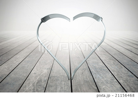 Forks heart on wood background 21156468