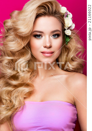 Beautiful young woman with long hair posing on 21166022