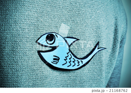 young man with a paper fish attached to his back young man with a paper fish attached to his back 21168762