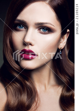 Portrait of beautiful girl with red lips. 21169214