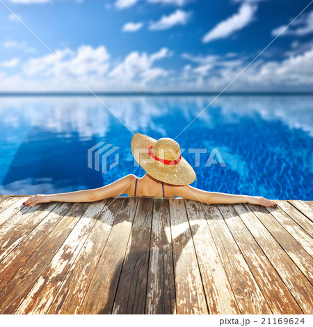 Woman at poolside Woman at poolside 21169624