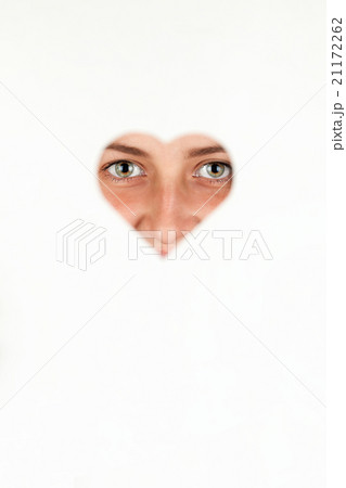 Girl looking through a heart 21172262