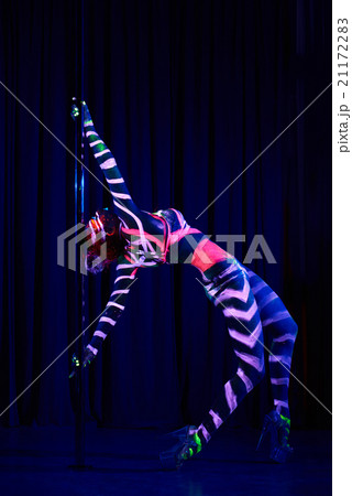 Female pole dancer in neon colours under ultraviolet (UV) light 21172283