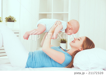 happy family mother playing with baby in bed happy family mother playing with baby in bed 21172320