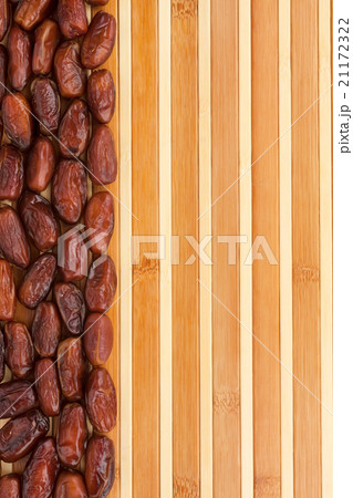 Dried dates lying on a bamboo mat Dried dates lying on a bamboo mat 21172322