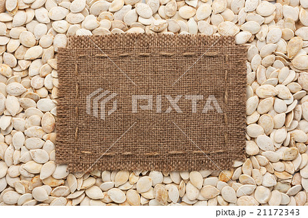 Frame made of burlap on  pumpkin seeds 21172343