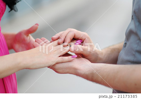 groom puts ring on the bride's hand. close-up groom puts ring on the bride's hand. close-up 21173385