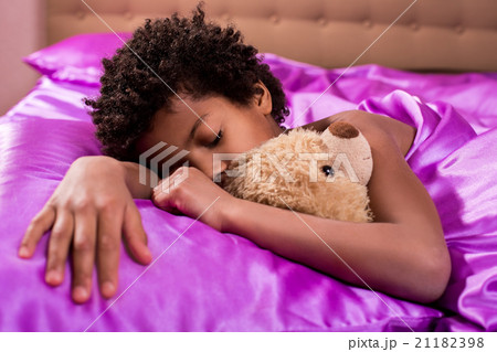 Afro boy sleeping with teddybear. Afro boy sleeping with teddybear. 21182398