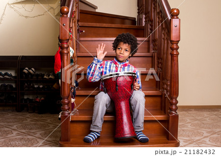 Boy with drum on stairs. Boy with drum on stairs. 21182432