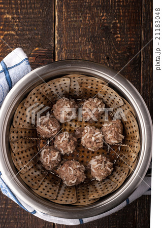 Meatball in the steamer on the wooden table 21183048