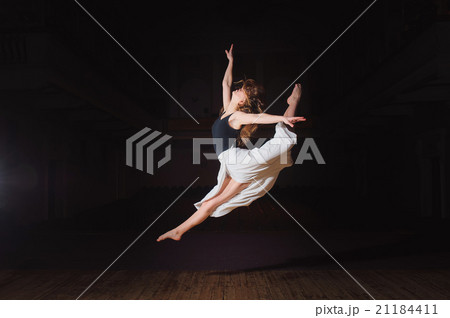 Young brunette dancer girl in split jump Young brunette dancer girl in split jump 21184411
