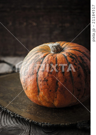 Orange pumpkin with green stripes on the tray Orange pumpkin with green stripes on the tray 21184517