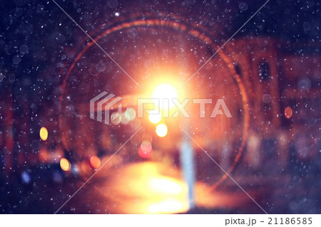 city lights on winter road, blurred background snowfall 21186585