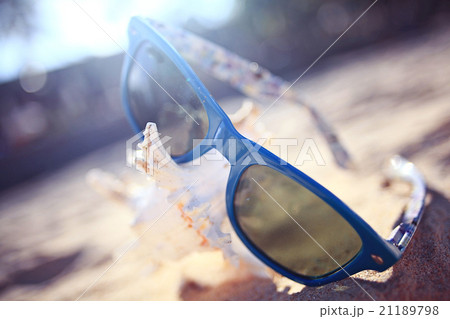 sunglasses on a sandy beach concept Summer sunglasses on a sandy beach concept Summer 21189798