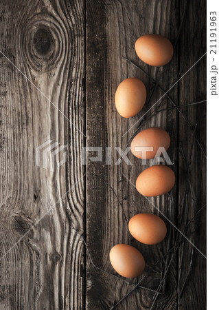 Chicken eggs on a wooden table 21191963