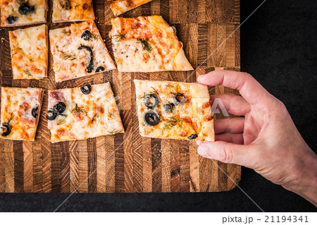 Slices of pizza on a wooden board Slices of pizza on a wooden board 21194341