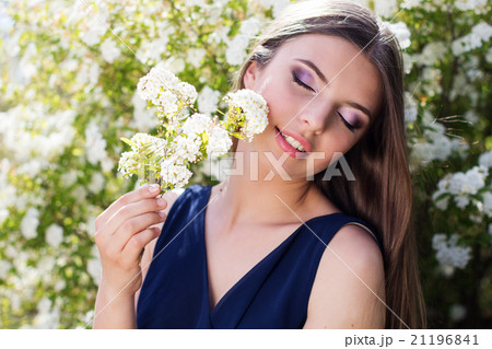 Beautiful girl with white blossom flowers Beautiful girl with white blossom flowers 21196841