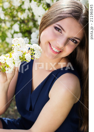 Pretty smiling teen girl with white flowers Pretty smiling teen girl with white flowers 21196845