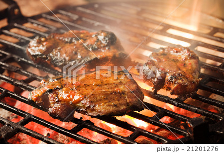 Grilling marinated meat Grilling marinated meat 21201276