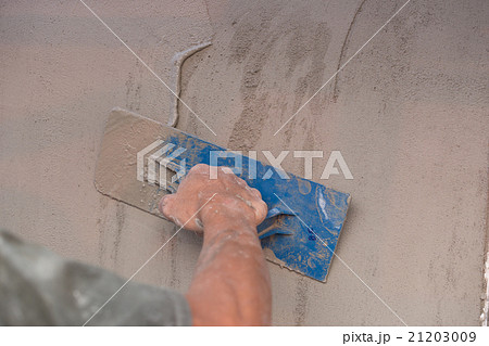 hand of worker use trowel plastering concrete wall hand of worker use trowel plastering concrete wall 21203009