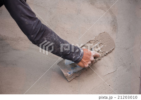 hand of worker use trowel plastering concrete wall hand of worker use trowel plastering concrete wall 21203010