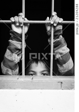 asian boy Hand in jail,black and white tone 21204288