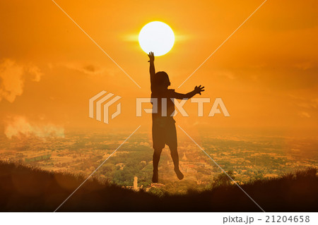 boy happy jumping touch  the sun 21204658