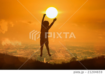 boy happy jumping touch  the sun 21204659