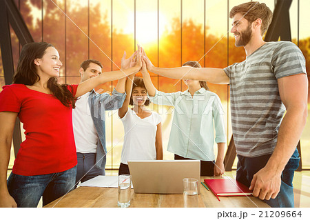 Composite image of happy business team putting their hands toget 21209664