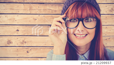 Composite image of smiling hipster woman looking at camera Composite image of smiling hipster woman looking at camera 21209937