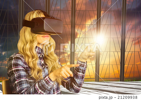 Composite image of pretty casual worker using oculus rift 21209938