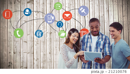 Composite image of young creative team looking at tablet 21210076