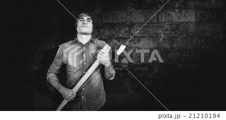 Composite image of front view of hipster standing with axe Composite image of front view of hipster standing with axe 21210194
