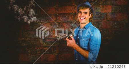 Composite image of cheerful hipster holding pipe Composite image of cheerful hipster holding pipe 21210243