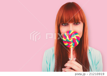Composite image of smiling hipster woman with a lollipop 21210919