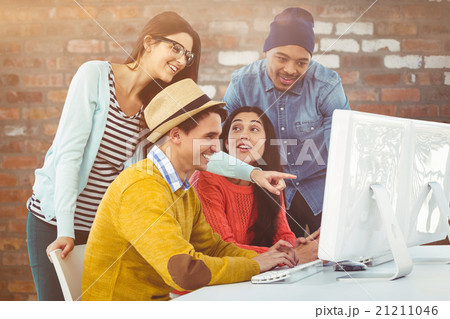 Composite image of young creative team having a meeting Composite image of young creative team having a meeting 21211046