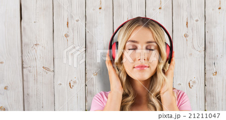 Composite image of close up of a woman listening to music 21211047