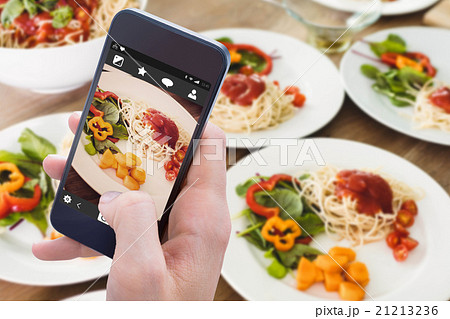 Composite image of woman using her mobile phone Composite image of woman using her mobile phone 21213236
