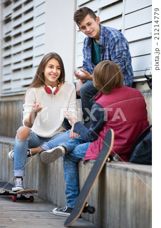 Three teenagers hanging out outdoors Three teenagers hanging out outdoors 21214779